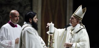 Pope Francis presides over a solemn Easter vigil ceremony in St. Peter's Basilica empty of the faithful following Italy’s ban on gatherings to contain coronavirus contagion, at the Vatican, Saturday, April 11, 2020. The new coronavirus causes mild or moderate symptoms for most people, but for some, especially older adults and people with existing health problems, it can cause more severe illness or death. (Remo Casilli/Pool Photo via AP)