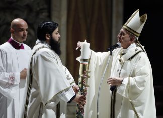 Pope Francis presides over a solemn Easter vigil ceremony in St. Peter's Basilica empty of the faithful following Italy’s ban on gatherings to contain coronavirus contagion, at the Vatican, Saturday, April 11, 2020. The new coronavirus causes mild or moderate symptoms for most people, but for some, especially older adults and people with existing health problems, it can cause more severe illness or death. (Remo Casilli/Pool Photo via AP)