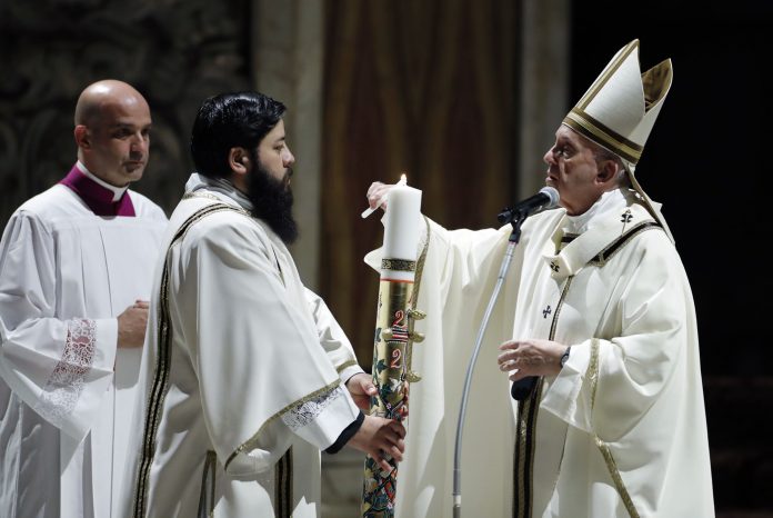 Pope Francis presides over a solemn Easter vigil ceremony in St. Peter's Basilica empty of the faithful following Italy’s ban on gatherings to contain coronavirus contagion, at the Vatican, Saturday, April 11, 2020. The new coronavirus causes mild or moderate symptoms for most people, but for some, especially older adults and people with existing health problems, it can cause more severe illness or death. (Remo Casilli/Pool Photo via AP)