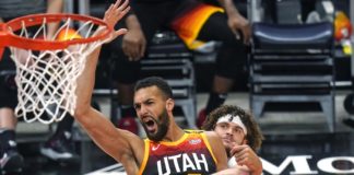 Utah Jazz center Rudy Gobert (27) and Brooklyn Nets guard Tyler Johnson, rear, work for position near the basket during the first half of an NBA basketball game Wednesday, March 24, 2021, in Salt Lake City. (AP Photo/Rick Bowmer)