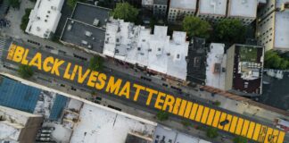 In this June 15, 2020, file photo, a giant "Black Lives Matter" sign is painted on Fulton Street in the Brooklyn borough of New York. A report released on Wednesday, Aug. 25, 2021 says 16% of American households donated to racial and social justice causes in 2020, resulting in a 3% uptick from 2019 as donors raced to provide support to affected communities in a year marked by protests and increased attention on racism in America. (AP Photo/John Minchillo, File)