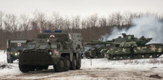 Ukrainian armored vehicles drive during military drills close to Kharkiv, Ukraine, Thursday, Feb. 10, 2022. Britain\'s top diplomat has urged Russia to take the path of diplomacy even as thousands of Russian troops engaged in sweeping maneuvers in Belarus as part of a military buildup near Ukraine. (AP Photo/Andrew Marienko)