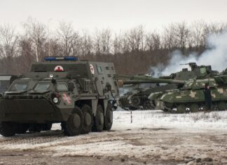 Ukrainian armored vehicles drive during military drills close to Kharkiv, Ukraine, Thursday, Feb. 10, 2022. Britain\'s top diplomat has urged Russia to take the path of diplomacy even as thousands of Russian troops engaged in sweeping maneuvers in Belarus as part of a military buildup near Ukraine. (AP Photo/Andrew Marienko)